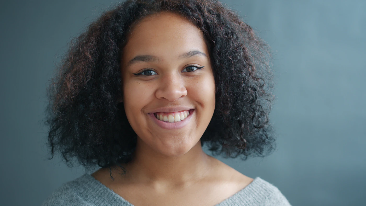 Young woman with curly hair smiling