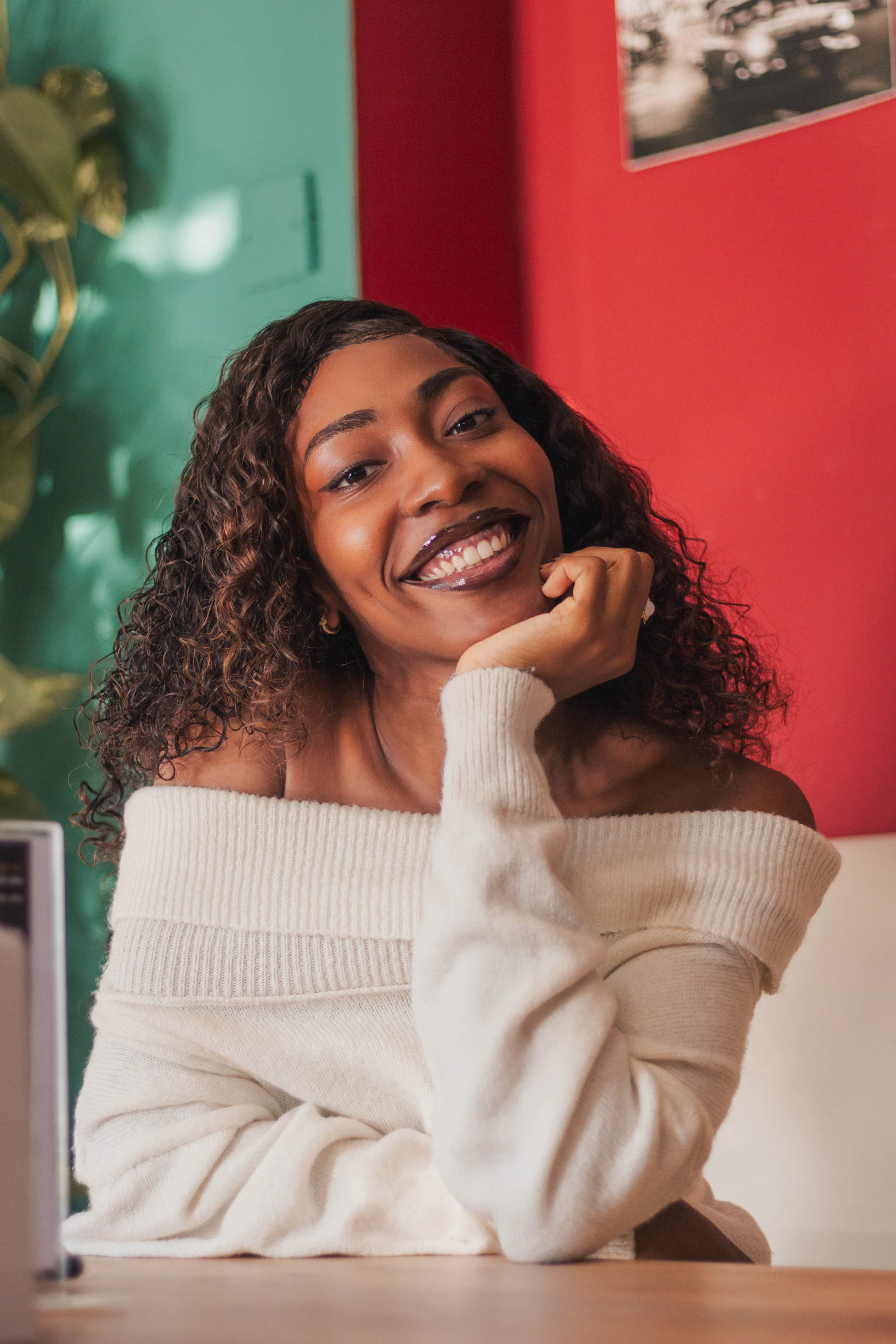 Woman with curly hair smiling warmly