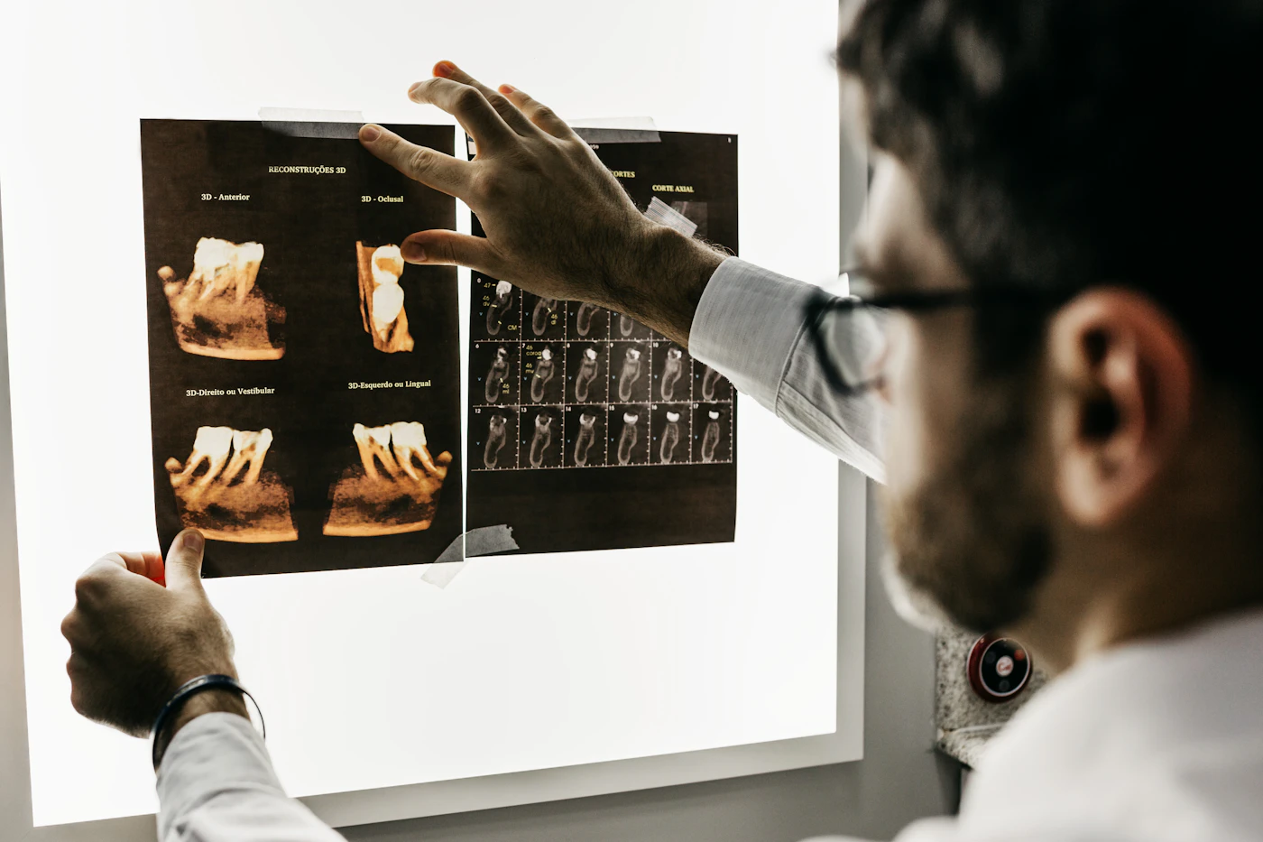 An orthodontist reviewing dental X-rays